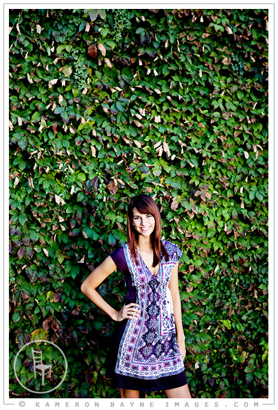 inspired fashion picture of a girl in a purple dress in front of a green leaf wall