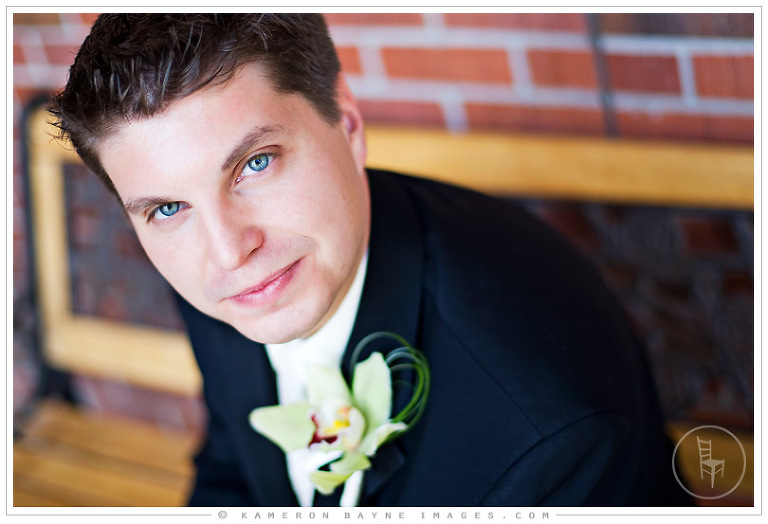 close up of groom sitting on park bench