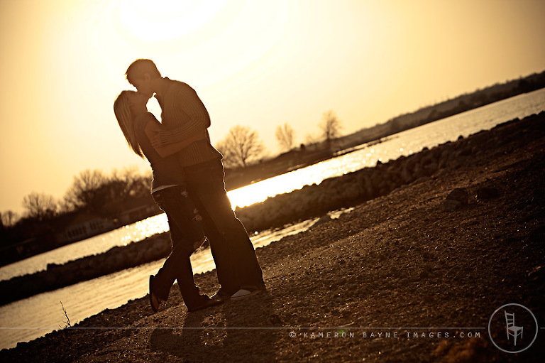 magical kiss between lovers as the sun sets on the water
