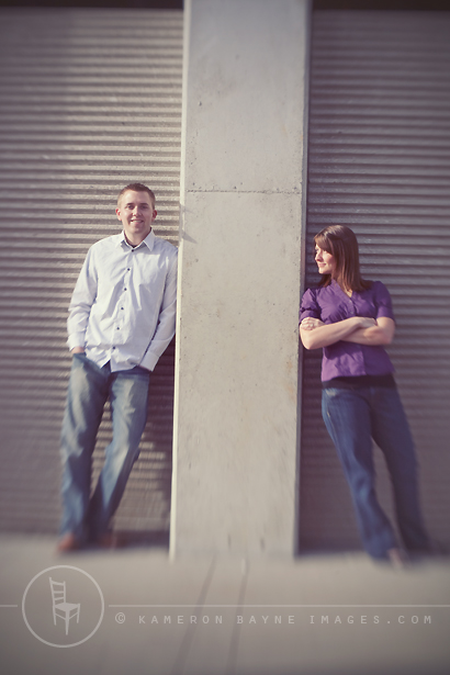engaged couple split by wall