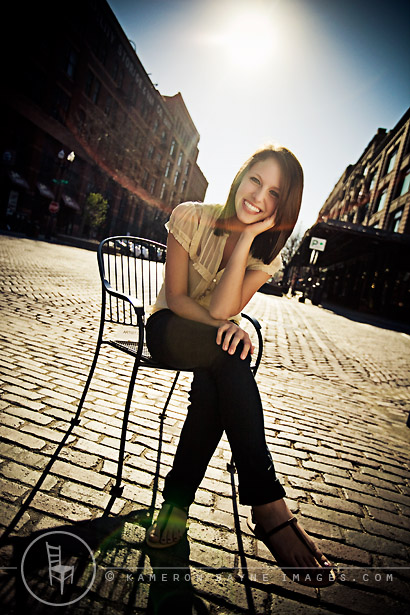 senior portrait of Anna, back lit on cobble stone street