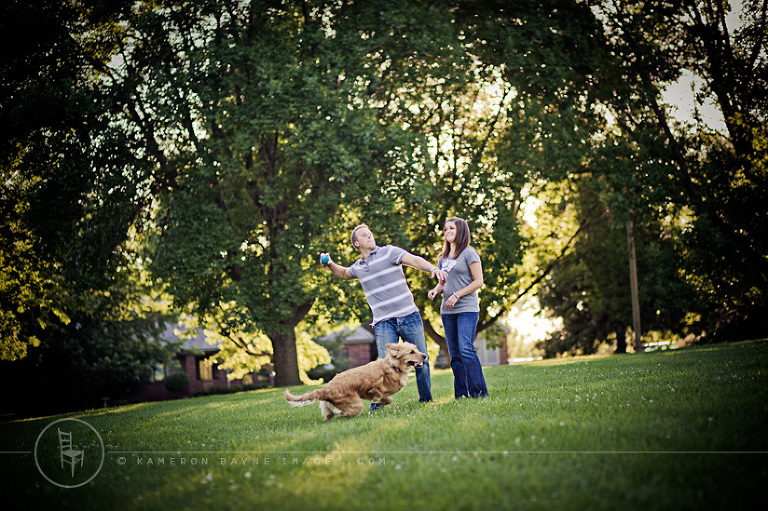 Liz and Cory playing fetch with their dog in the park