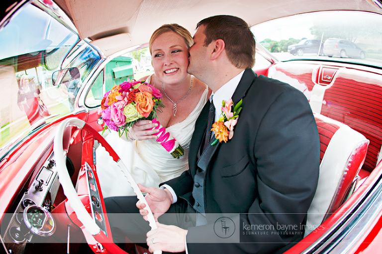 Romantic Kiss of Bride and Groom in Old Vintage Car
