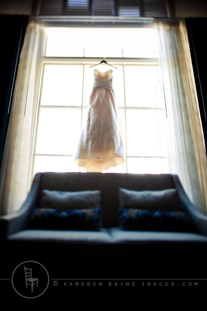 Kameron Bayne Images - The Wedding Dress designer wedding dress hanging in window captured with tilt shift lens