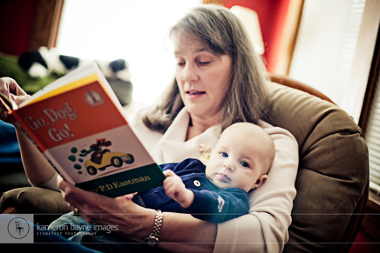 Four month old catching up on his reading with Grandma