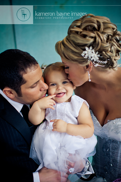 Dan + Lindsay | a wedding kiss with their adorable baby girl