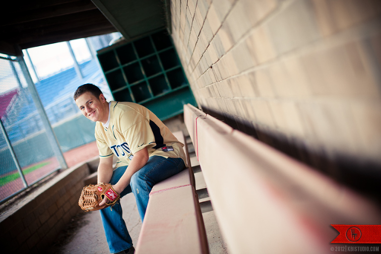 High school senior, Jacob, sits in the dugout of the Elkhorn baseball field.